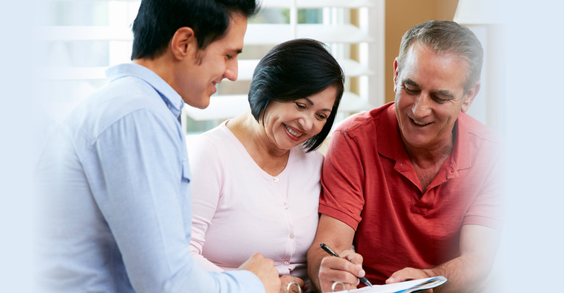 Financial Advisor Talking To Senior Couple At Home