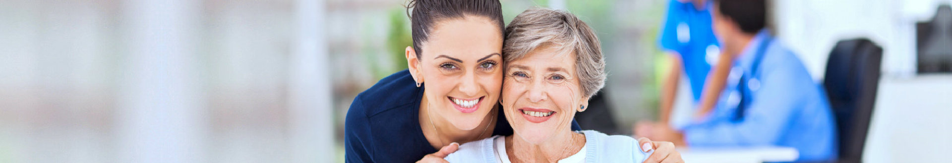 elder woman and caregiver smiling
